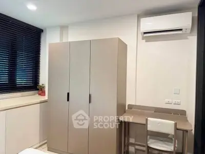 Cozy bedroom with modern wardrobe and air conditioning, perfect for comfortable living.