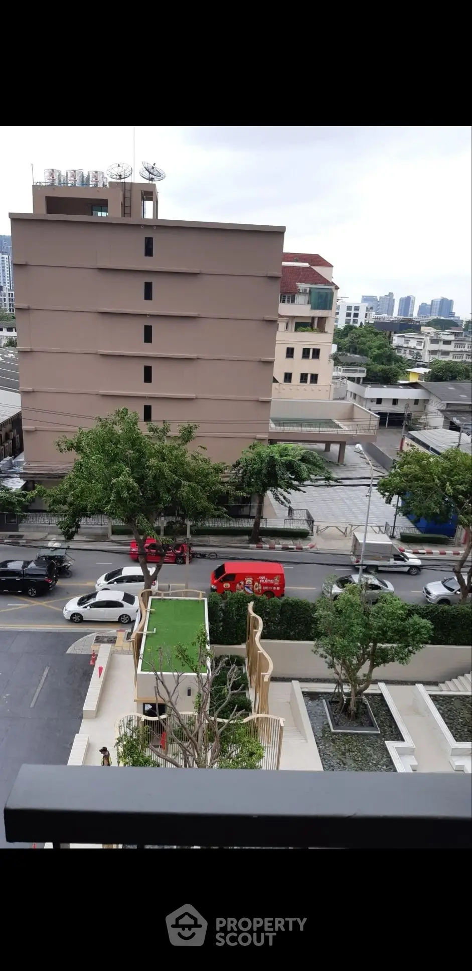 Urban view from balcony overlooking city street and buildings