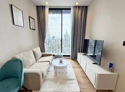 Modern living room with city view, cozy sofa, and sleek TV setup.