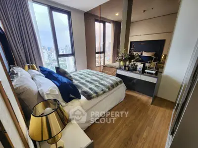 Luxurious bedroom with city view, elegant decor, and modern furnishings in high-rise apartment.