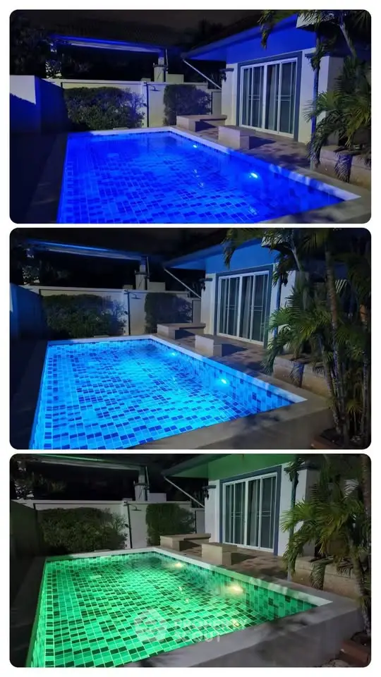 Stunning illuminated pool with vibrant LED lighting in a modern backyard setting.