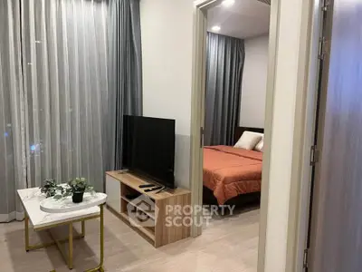 Modern apartment interior with cozy living room and bedroom, featuring stylish decor and natural light.