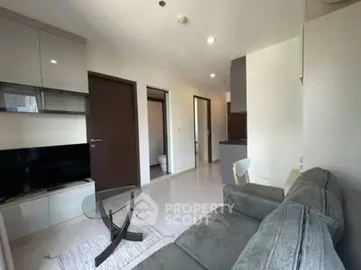 Modern living room with sleek furniture and open kitchen layout