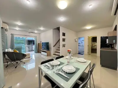 Modern open-plan living and dining area with sleek kitchen and stylish decor