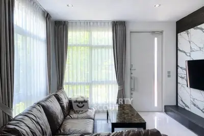 Modern living room with leather sofa and marble accent wall