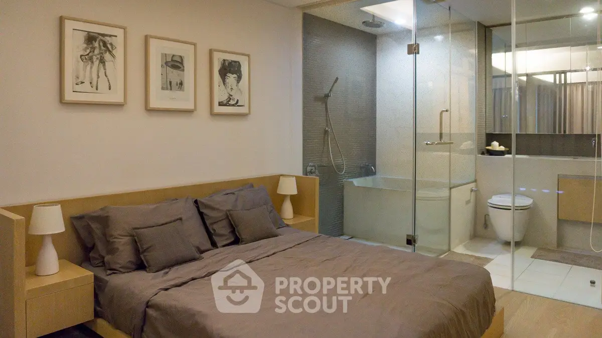 Modern bedroom with ensuite glass-walled bathroom and stylish decor