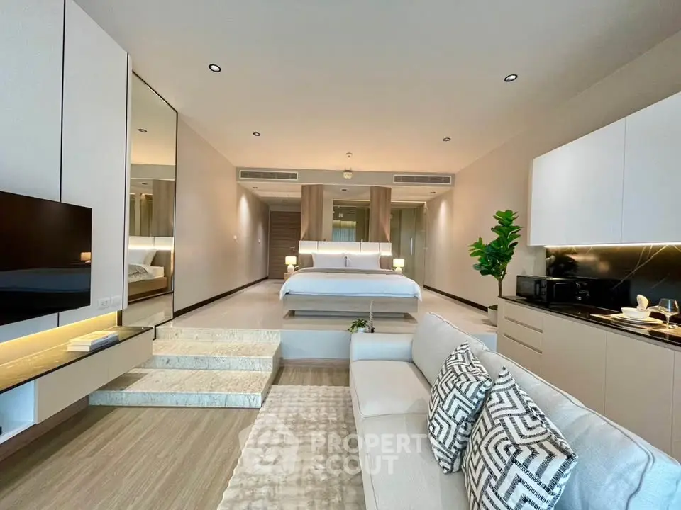 Luxurious open-plan studio with modern decor and cozy living area, perfect for urban living.
