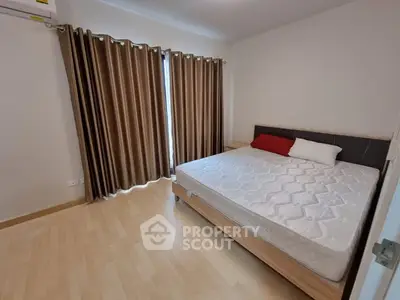 Spacious bedroom with large window and modern decor