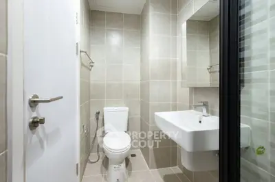 Modern bathroom with sleek fixtures and neutral tiles, perfect for a contemporary home.