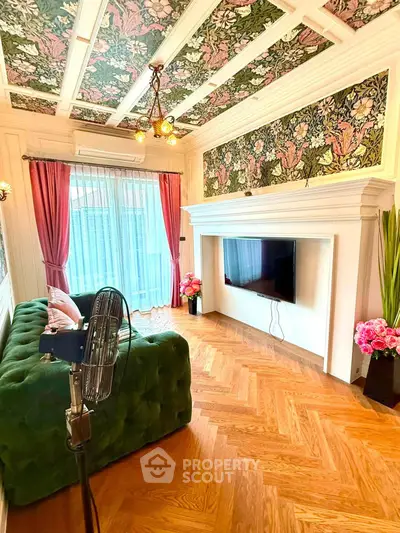 Luxurious living room with elegant decor, floral ceiling, and stylish green sofa, perfect for modern living.