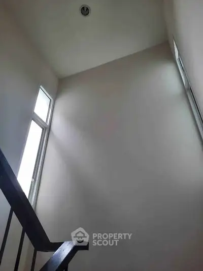 Minimalist stairwell with high ceiling and natural light
