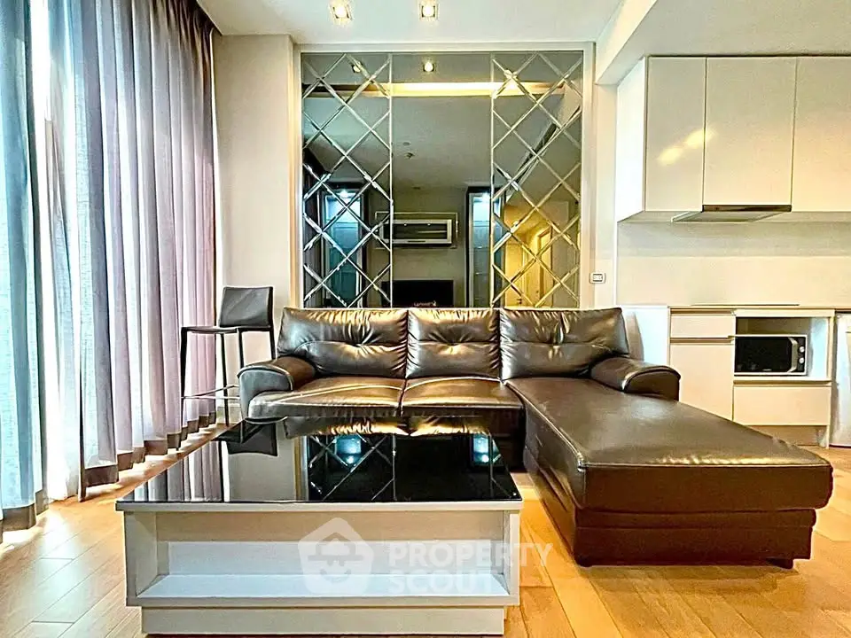 Luxurious modern living room with leather sofa and mirrored wall in a stylish apartment.