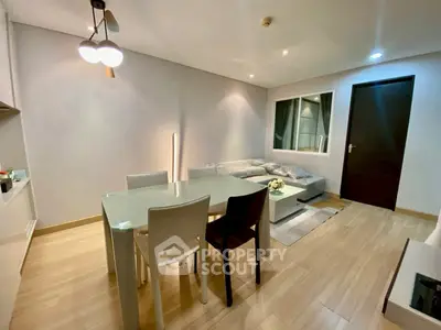 Modern living room with stylish dining area and cozy seating.