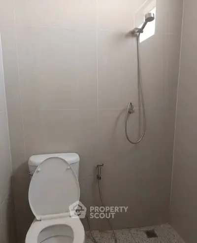 Minimalist bathroom with shower and toilet in modern apartment