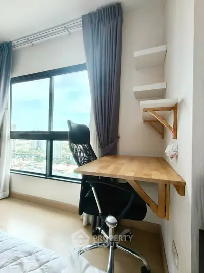 Modern study nook with city view, featuring a sleek desk and ergonomic chair.