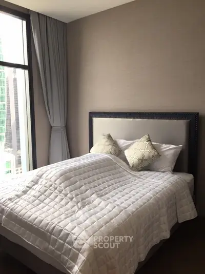 Cozy bedroom with large window and elegant decor in modern apartment