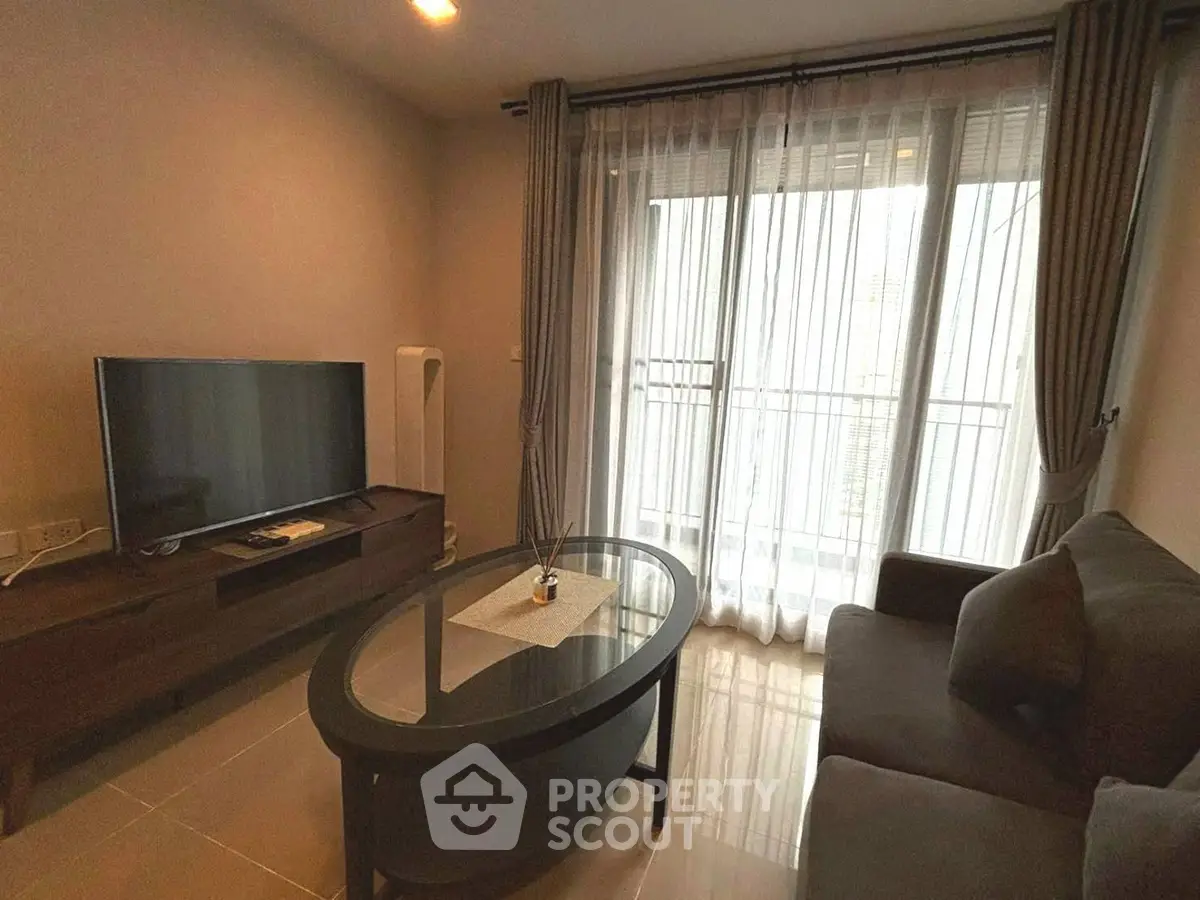 Cozy living room with modern furniture and large window for natural light