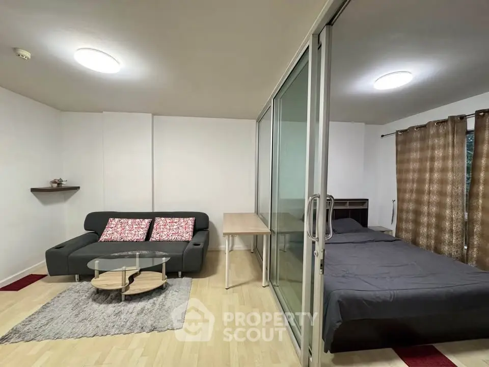 Modern studio apartment with glass partition and cozy furnishings