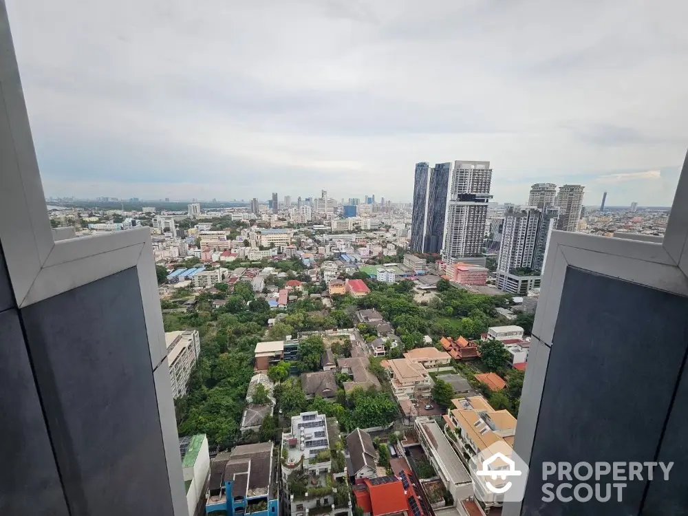 Stunning cityscape view from high-rise building showcasing urban skyline and greenery.