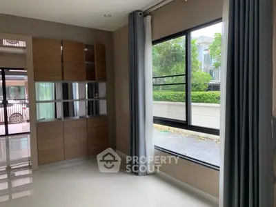 Modern interior with large window and built-in wooden storage unit