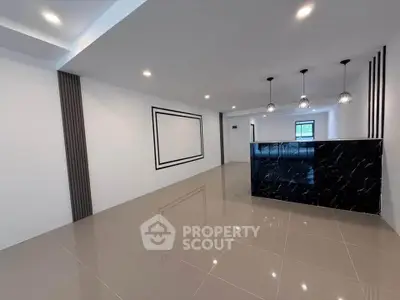 Modern open layout living room with sleek black marble counter and stylish lighting