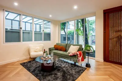 Stylish living room with modern decor and large windows offering natural light.