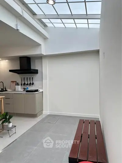 Modern kitchen with skylight and sleek cabinetry in open layout