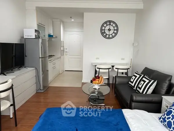 Modern studio apartment with stylish decor and compact kitchen