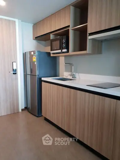 Modern kitchen with sleek wooden cabinets and stainless steel appliances