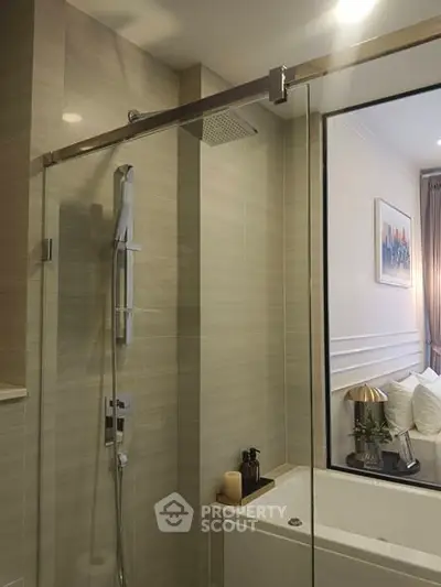 Modern bathroom with glass shower and elegant decor in a stylish apartment.