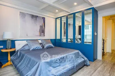 Elegant bedroom with modern blue wardrobe and stylish decor