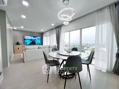 Spacious modern living room with panoramic city views and elegant dining area.