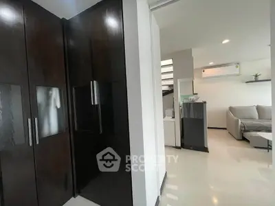 Modern interior with sleek black cabinets and cozy living area