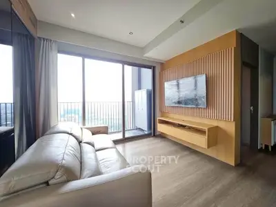 Modern living room with large windows and balcony access in a stylish apartment.