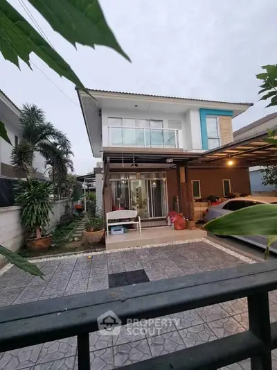 Charming two-story house with spacious driveway and lush garden, perfect for family living.
