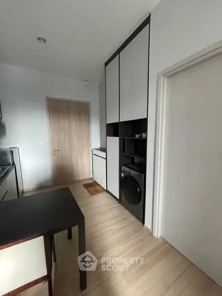 Modern kitchen with sleek cabinetry and built-in washing machine
