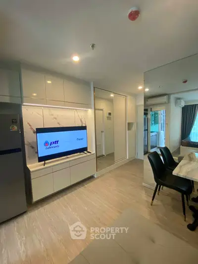 Modern living room with sleek TV setup and stylish dining area
