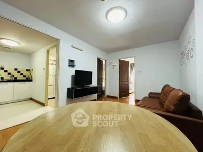 Spacious living room with modern decor and open kitchen layout