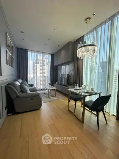 Luxurious modern living room with city view, elegant chandelier, and stylish furnishings.