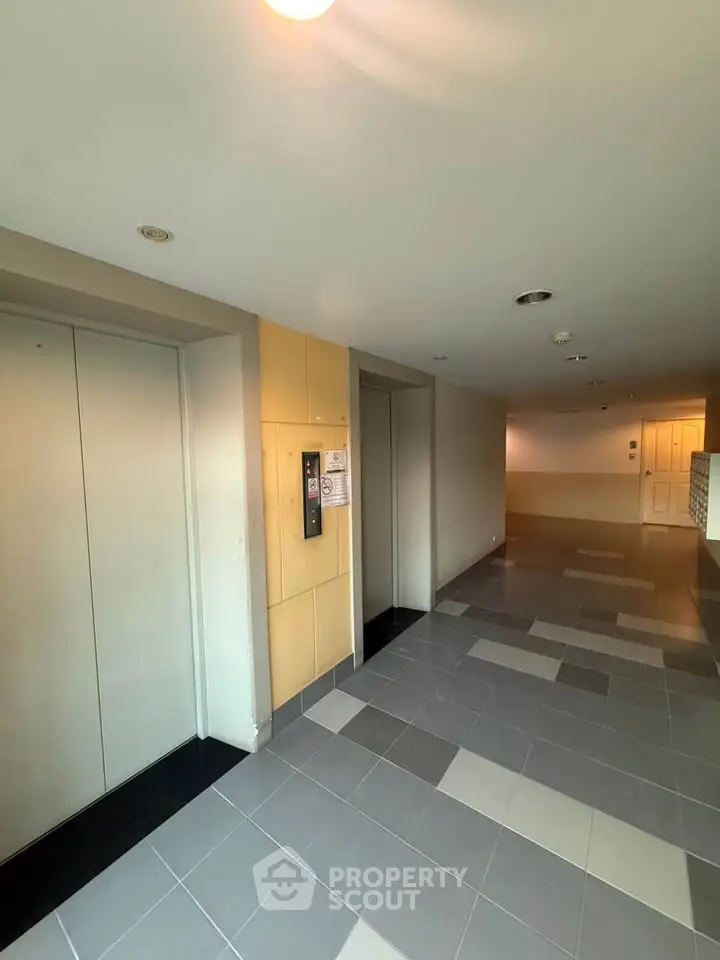 Modern building elevator lobby with sleek design and tiled flooring