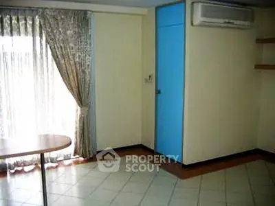Spacious room with large window and air conditioning, ideal for modern living.