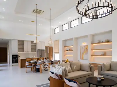 Luxurious open-plan living room with modern kitchen and elegant chandelier