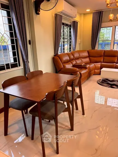 Spacious living room with modern furniture and large windows for natural light.