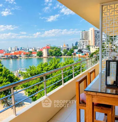 Stunning balcony view overlooking river and city skyline, perfect for relaxation and entertainment.