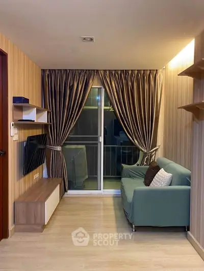 Cozy living room with modern decor and balcony access in a stylish apartment.