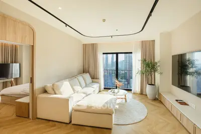 Luxurious living room with modern decor and city view balcony