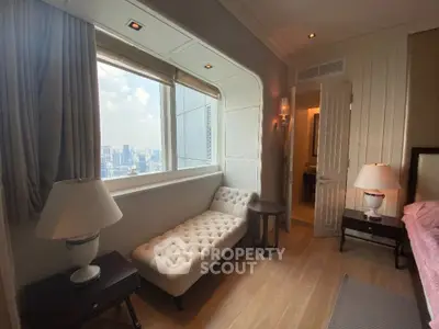 Luxurious bedroom with city view and elegant chaise lounge