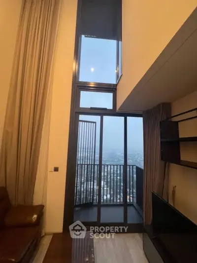 Modern high-rise apartment with floor-to-ceiling windows and balcony offering stunning city views.