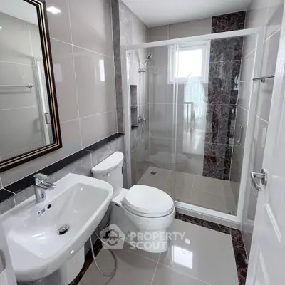 Modern bathroom with sleek fixtures and glass shower enclosure