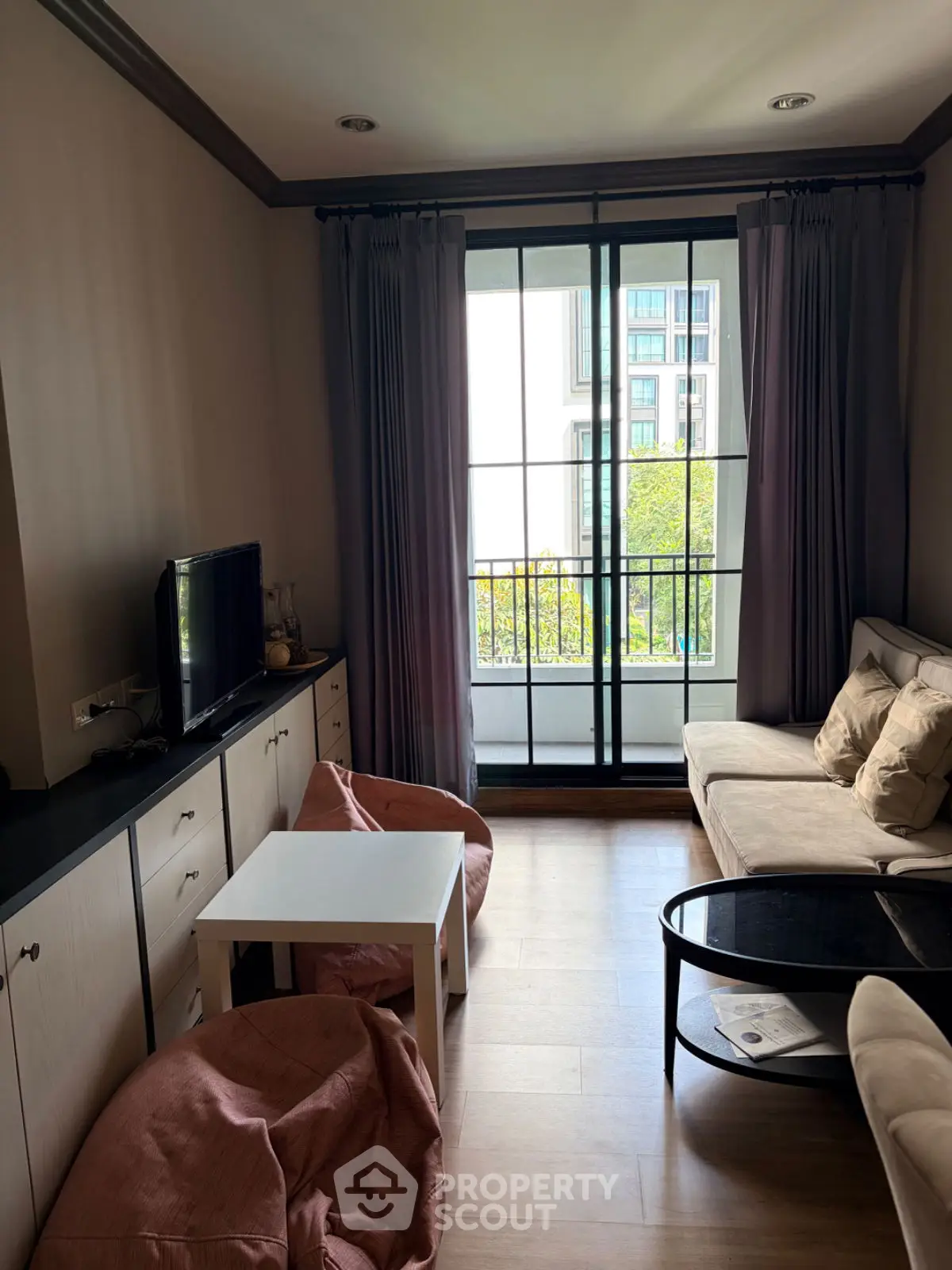 Cozy living room with modern decor and balcony view in urban apartment